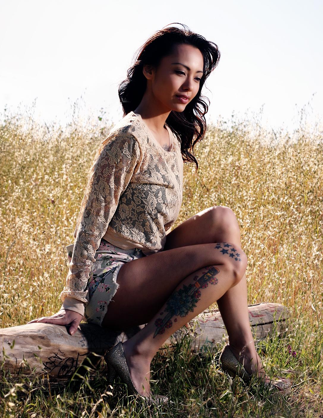 Brunette Asian Girl wearing Blue Denim Mini Skirt with Bare Tatooed Legs